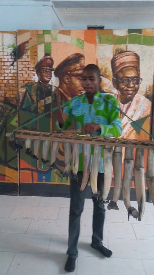 Musician performing on a traditional balafon